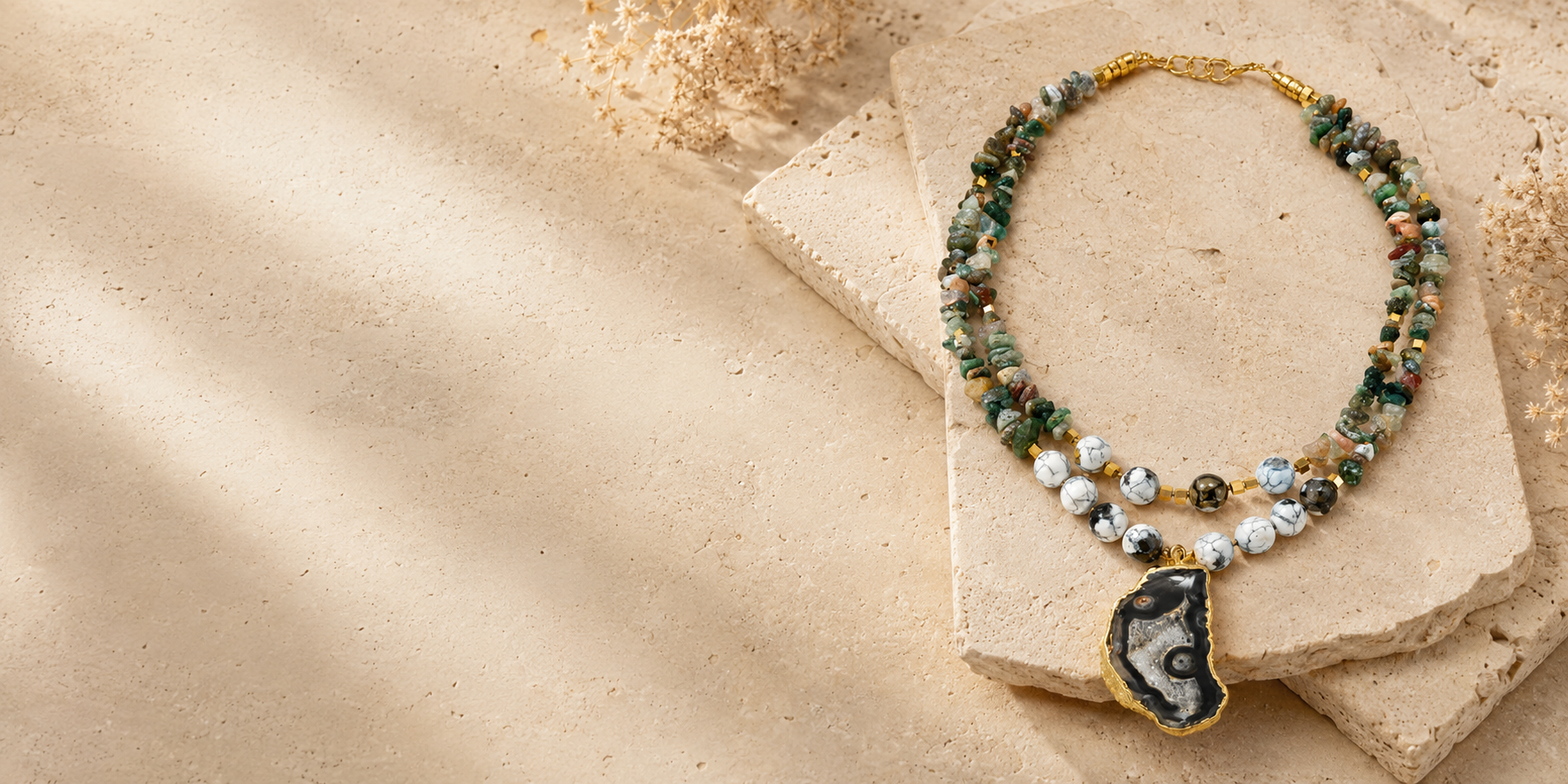 Pathrohi handcrafted natural-stone necklace on warm sandstone