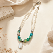 Angled view of Clear Stone & Aqua Agate Drop Necklace handcrafted by Pathrohi