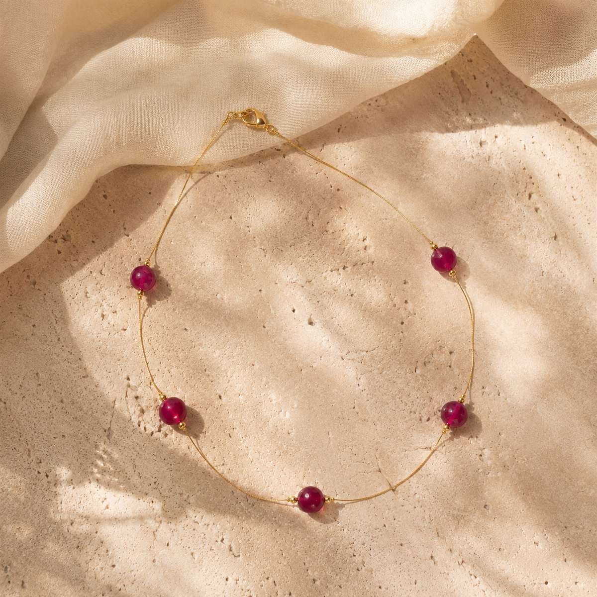 Close-up of Ruby Dew Fine Wire Necklace showing pendant and finishing details