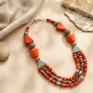 Angled view of Coral Agate Elephant Multi-Strand Necklace handcrafted by Pathrohi