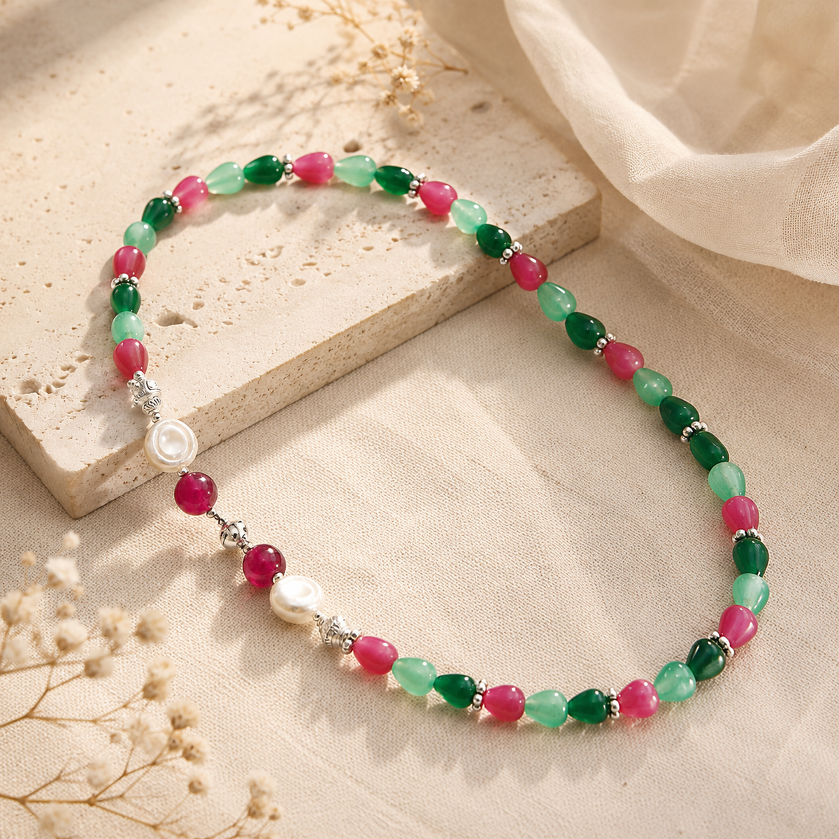 Angled view of Emerald Ruby Teardrop Necklace handcrafted by Pathrohi