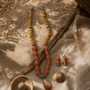Angled view of Orange Sunset Agate Pendant Set handcrafted by Pathrohi