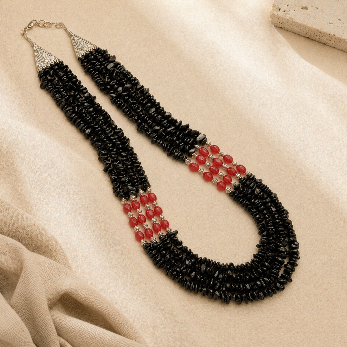 Angled view of Black & Red Agate Three-Layer Necklace handcrafted by Pathrohi